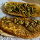 The inside of the sandwich features a long round chicken patty that kind of looks like a McDonald’s hash brown, a squeeze of “ghost pepper queso,” and crispy jalapeño chips.
